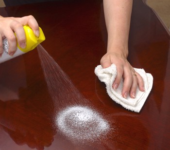 Hands Polishing a Wooden Table