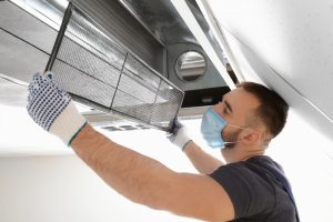  A man cleaning a homes air ducts